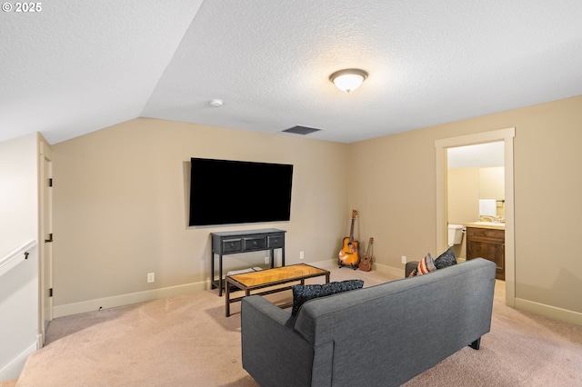 carpeted living room featuring a textured ceiling and vaulted ceiling