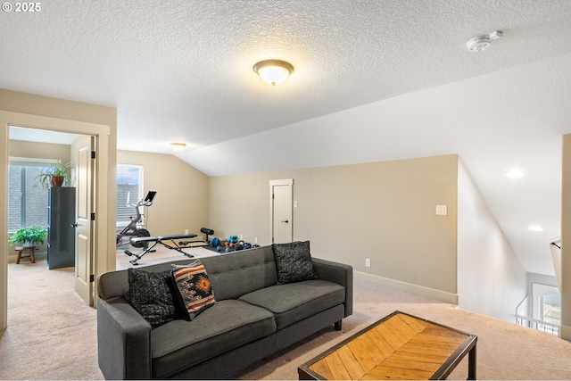 carpeted living room with a textured ceiling and vaulted ceiling