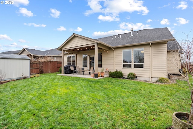 rear view of house featuring a lawn and a patio area