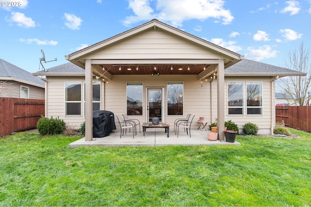 back of property featuring a yard and a patio area