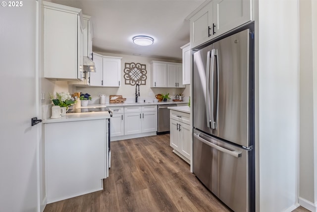 1109 SW 15th St, Lincoln City, OR 97367 - kitchen featuring appliances with stainless steel finishes, dark wood-style floors, ventilation hood, light countertops, and white cabinetry