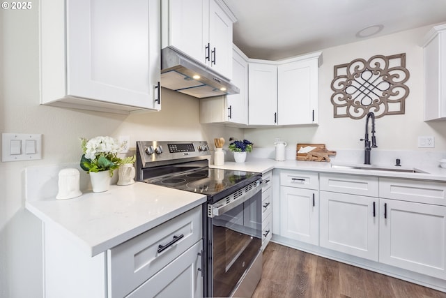 1109 SW 15th St, Lincoln City, OR 97367 - kitchen featuring stainless steel electric range oven, under cabinet range hood, light countertops, white cabinetry, and dark wood-style flooring