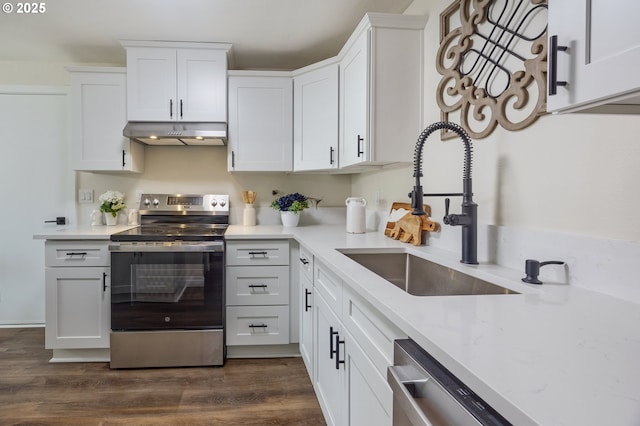 1109 SW 15th St, Lincoln City, OR 97367 - kitchen featuring stainless steel appliances, under cabinet range hood, white cabinetry, dark wood finished floors, and light stone countertops