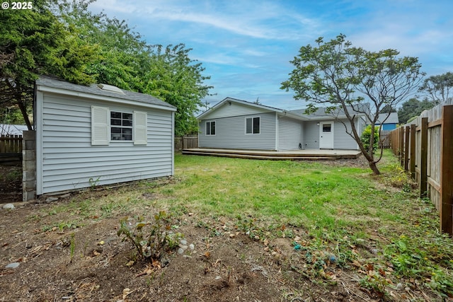 1109 SW 15th St, Lincoln City, OR 97367 - back of property with a fenced backyard, an outbuilding, and a wooden deck