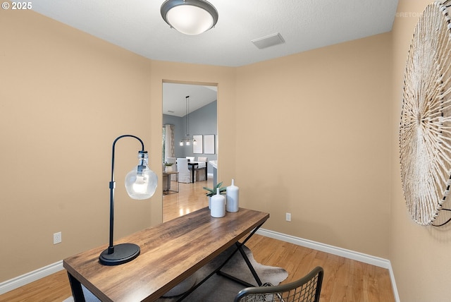 office space featuring baseboards and light wood-style floors