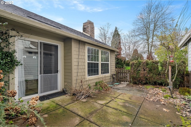 view of patio with a gate and fence