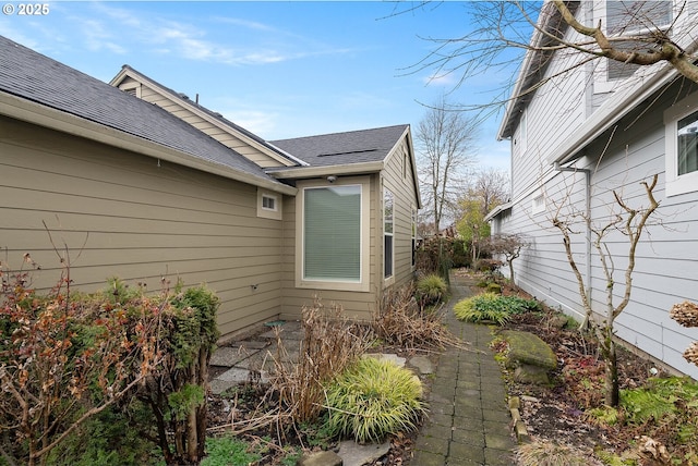 view of home's exterior with a shingled roof