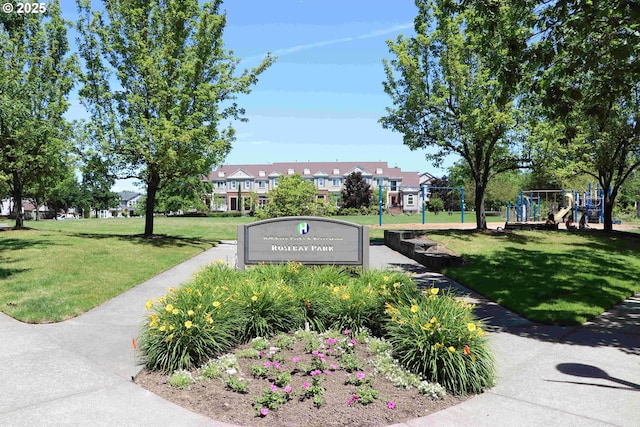 view of property's community with playground community and a lawn