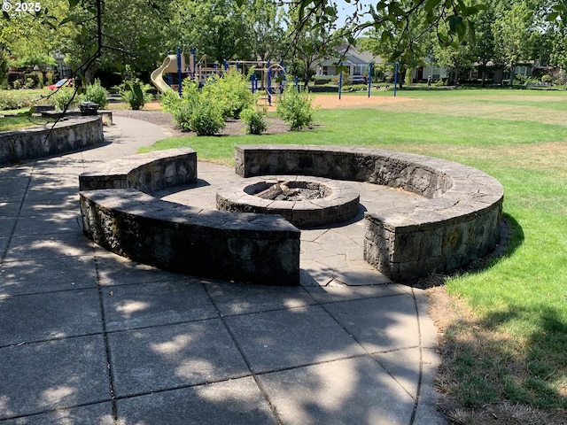 view of patio featuring a fire pit and playground community