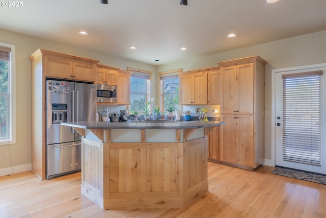 1202 SE Yarrow Ave, Madras, OR 97741 - kitchen with appliances with stainless steel finishes, light brown cabinets, a kitchen island, light wood-type flooring, and recessed lighting