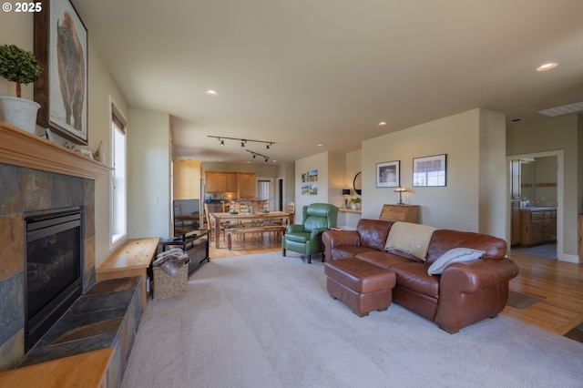 1202 SE Yarrow Ave, Madras, OR 97741 - living room featuring a tiled fireplace, recessed lighting, and rail lighting