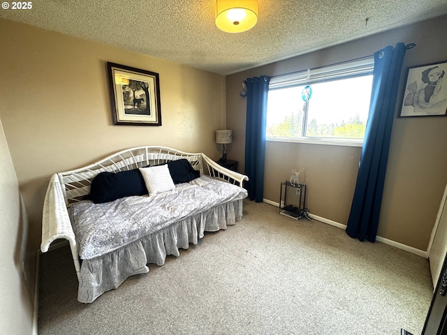 bedroom featuring carpet floors, a textured ceiling, and baseboards