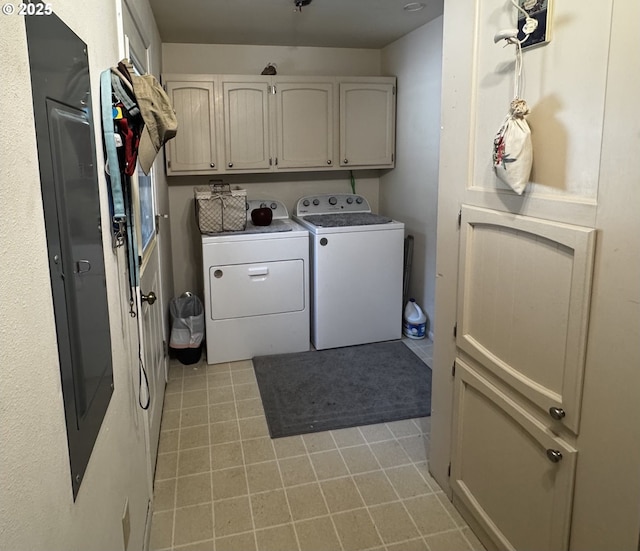 laundry room with cabinet space, independent washer and dryer, and light tile patterned floors