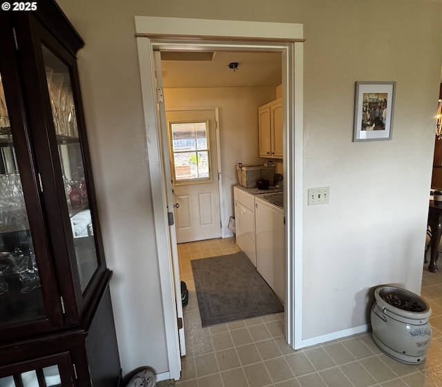 laundry room with cabinet space, tile patterned floors, baseboards, and washer / clothes dryer