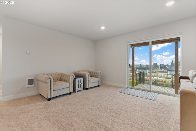 carpeted living room featuring a water view