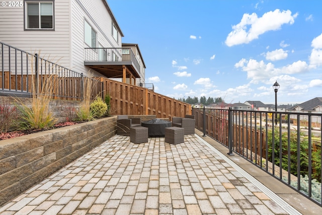 view of patio featuring an outdoor living space and a balcony