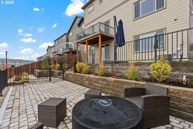 view of patio featuring grilling area and a balcony