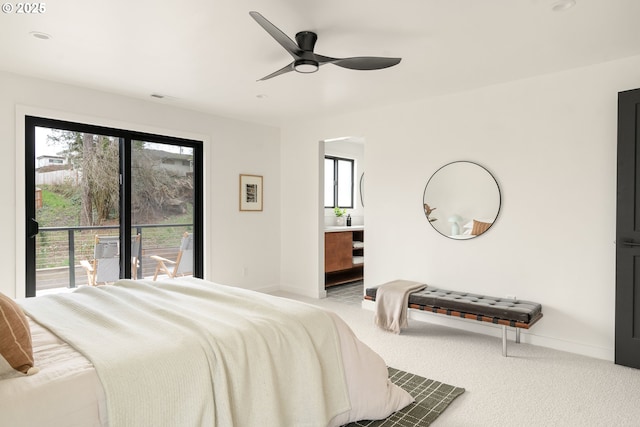 carpeted bedroom featuring access to outside, multiple windows, baseboards, and ceiling fan