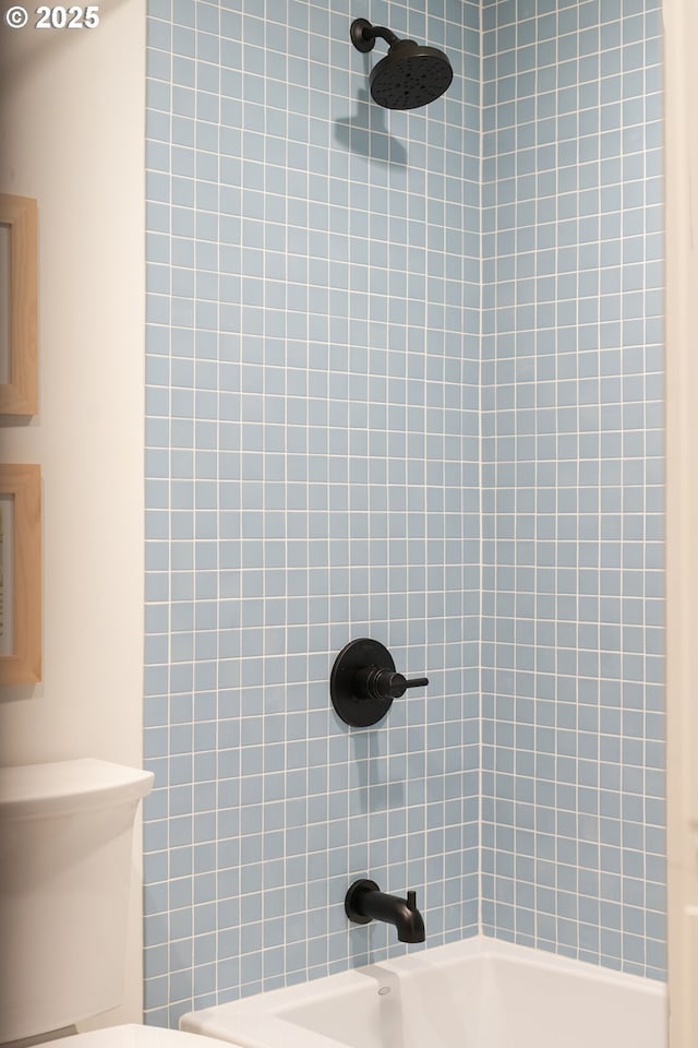 bathroom featuring toilet and shower / bathing tub combination