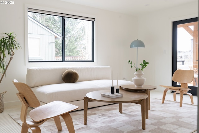 living area featuring light carpet