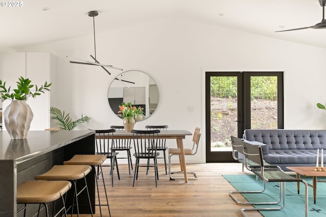 dining area featuring lofted ceiling and wood finished floors