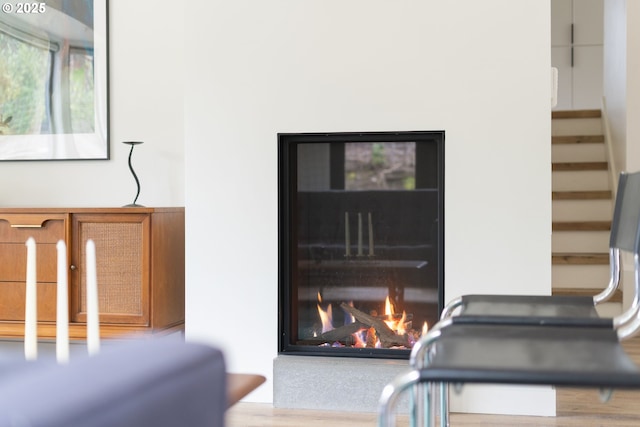 room details featuring a warm lit fireplace