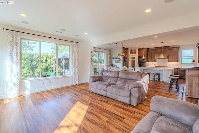 living room with recessed lighting, wood finished floors, and baseboards