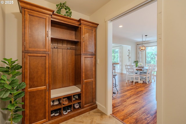 mudroom with recessed lighting, baseboards, an inviting chandelier, and light wood-style flooring