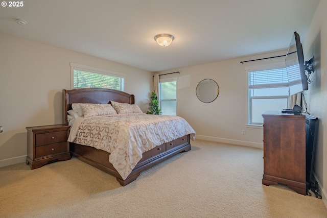 bedroom featuring baseboards and light carpet