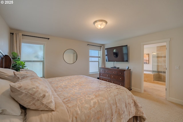 bedroom featuring connected bathroom, baseboards, and light carpet