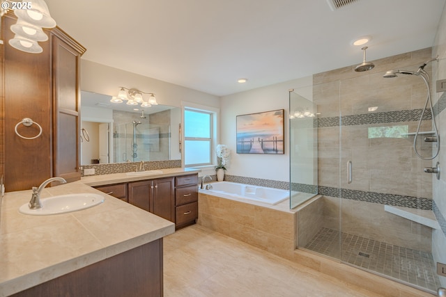 bathroom with vanity, a garden tub, a stall shower, and tile patterned flooring