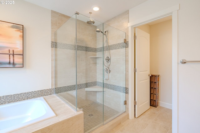 full bath featuring tile patterned floors, a garden tub, and a stall shower