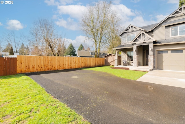 exterior space with concrete driveway and fence