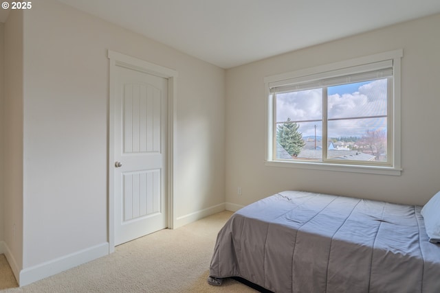 carpeted bedroom featuring baseboards