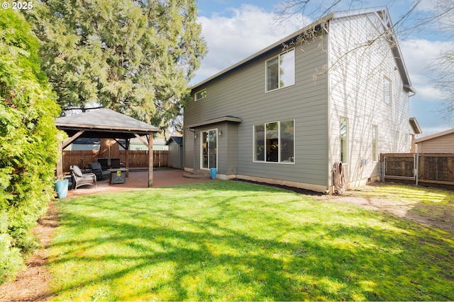 rear view of house with a gazebo, a yard, a fenced backyard, and a patio