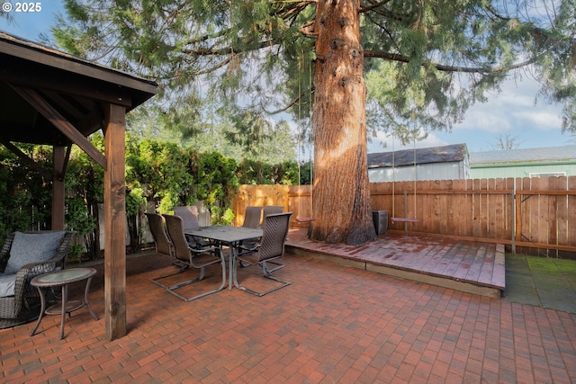 view of patio featuring outdoor dining space and a fenced backyard