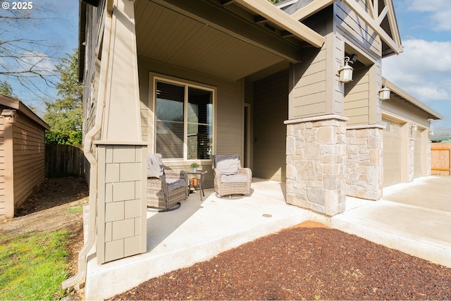 view of patio featuring a garage and fence