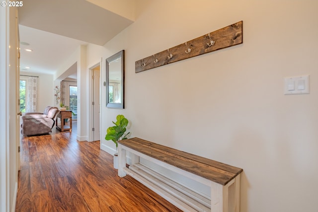 hallway featuring recessed lighting, wood finished floors, and baseboards