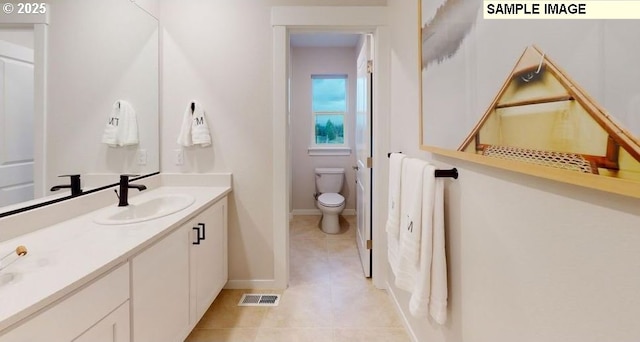 bathroom with tile patterned flooring, vanity, and toilet