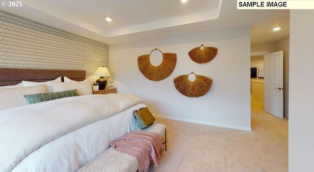 bedroom featuring carpet flooring and a raised ceiling