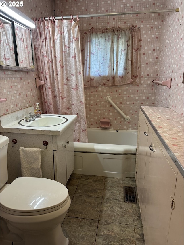 full bathroom featuring vanity, backsplash, tile patterned flooring, toilet, and shower / tub combo with curtain