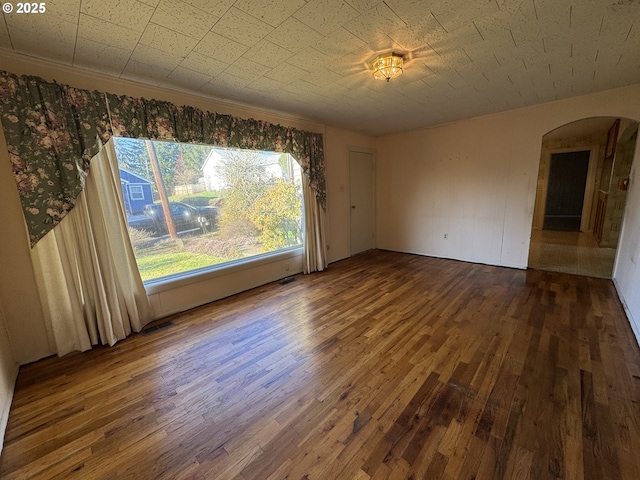 unfurnished room with dark wood-type flooring