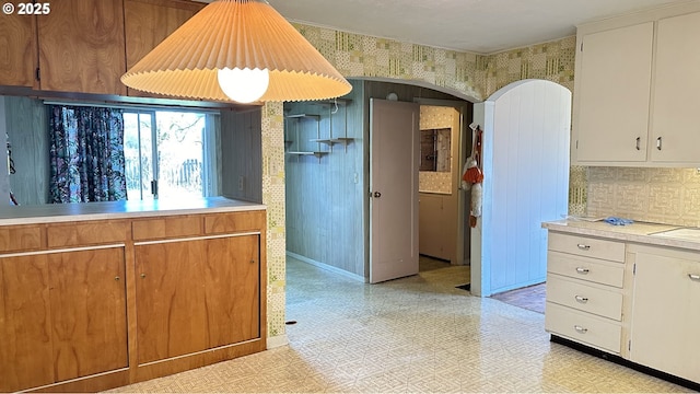 kitchen with decorative backsplash and white cabinetry