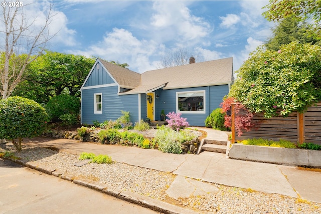 bungalow-style house featuring board and batten siding, a chimney, and a shingled roof