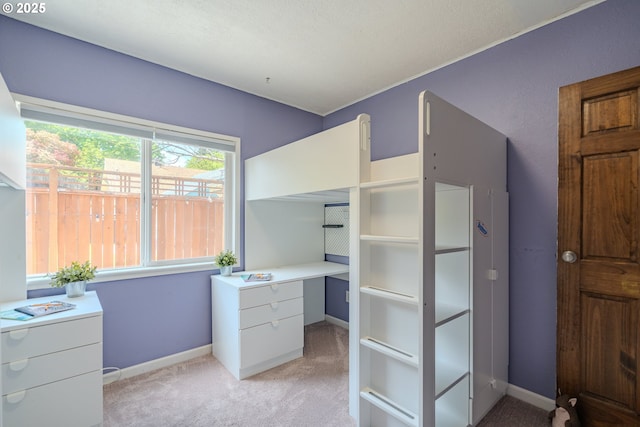 unfurnished bedroom featuring baseboards and light colored carpet
