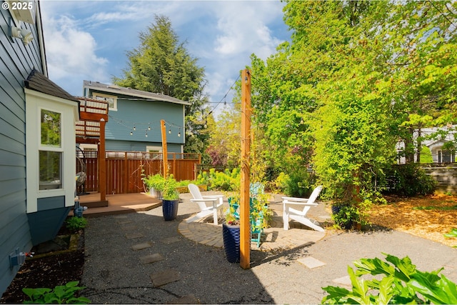 view of patio / terrace featuring fence and a wooden deck