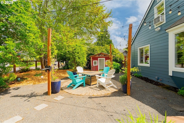 view of patio / terrace with an outbuilding and a shed