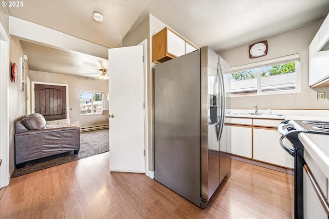 5246 SE 65th Ave, Portland, OR 97206 - kitchen with stainless steel refrigerator with ice dispenser, black range with electric stovetop, healthy amount of natural light, and light wood-style floors