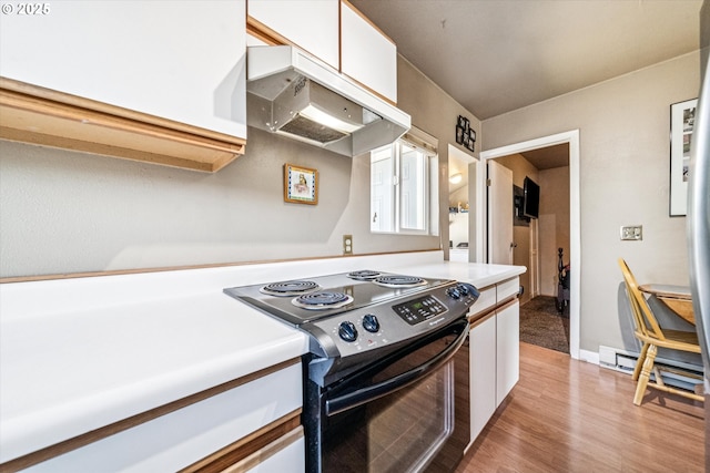 5246 SE 65th Ave, Portland, OR 97206 - kitchen with range with electric stovetop, under cabinet range hood, a baseboard radiator, white cabinetry, and light countertops