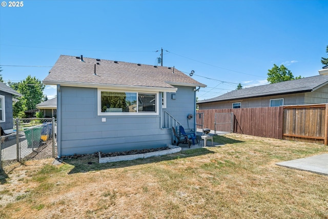5246 SE 65th Ave, Portland, OR 97206 - back of house with a fenced backyard and roof with shingles